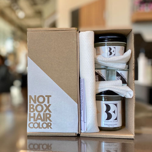 color enhancement collection jars and box on countertop