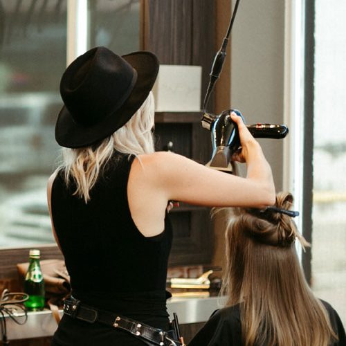 stylist styling hair at studio be salon