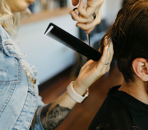 stylist cutting man's hair